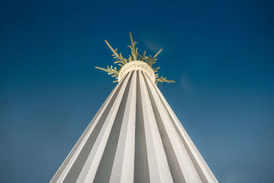 Low angle view of cross against blue sky