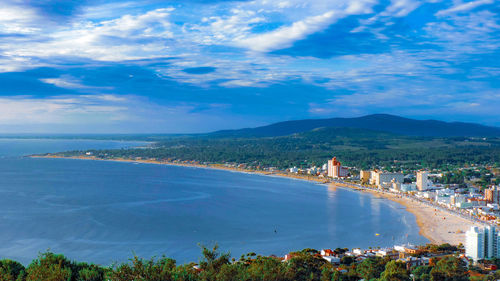 High angle view of sea and cityscape against sky