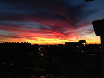 Silhouette city against sky at sunset