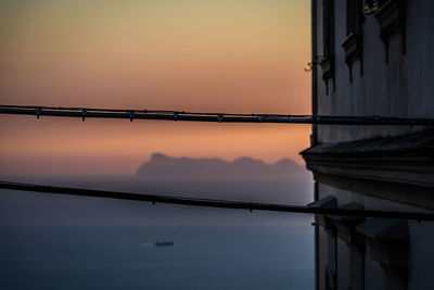 Illuminated bridge against sky during sunset