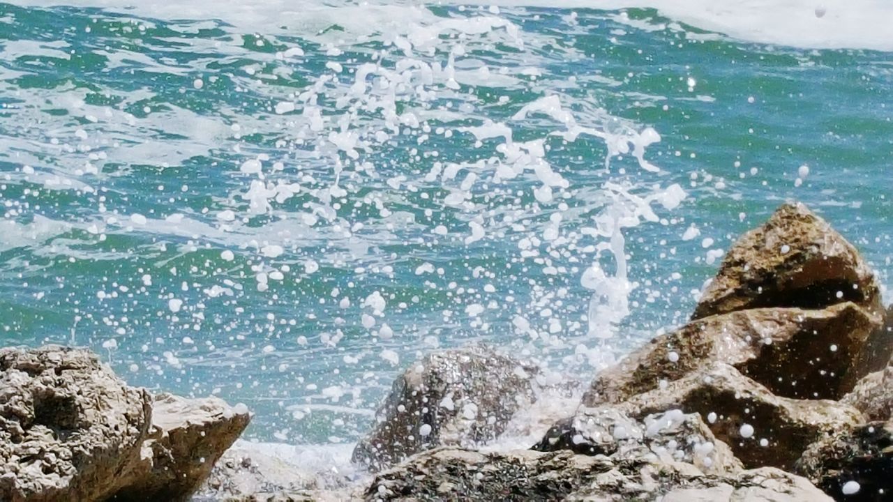water, sea, wave, rock - object, surf, beauty in nature, scenics, nature, splashing, rock formation, motion, tranquility, tranquil scene, shore, idyllic, day, outdoors, rock, high angle view, no people