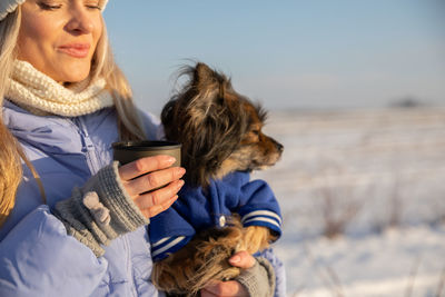 Side view of woman with dog at beach