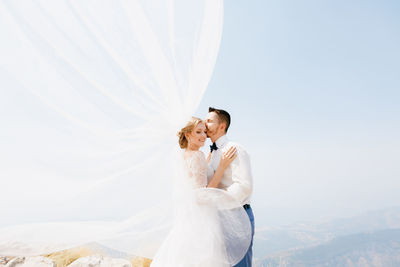 Young couple standing on field