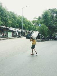 Full length of a woman walking on road