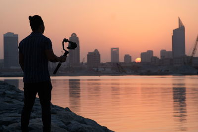 Photographer mesmerizing the beauty of the sunset