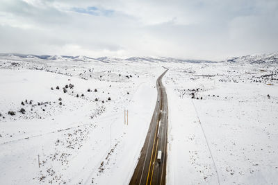 Aerial view of snowcapped mountains against sky