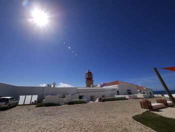 Low angle view of buildings against blue sky on sunny day