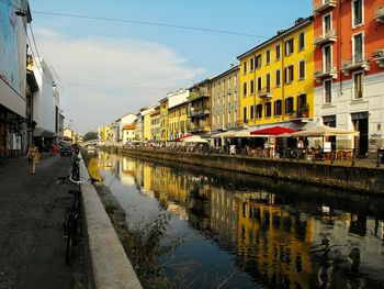 Reflection of buildings in canal on city street