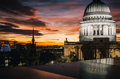 View of buildings in city against sky during sunset