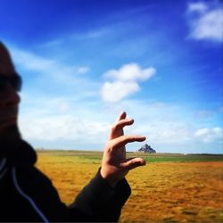 Cropped image of person standing on field against clear sky