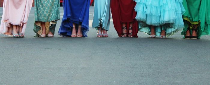 Low section of women standing on street