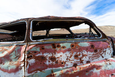 Old rusty car against sky
