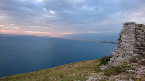 Scenic view of sea and mountains against sky