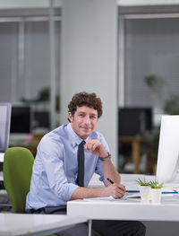 Portrait of businessman working at office