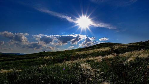 Scenic view of hill against sky