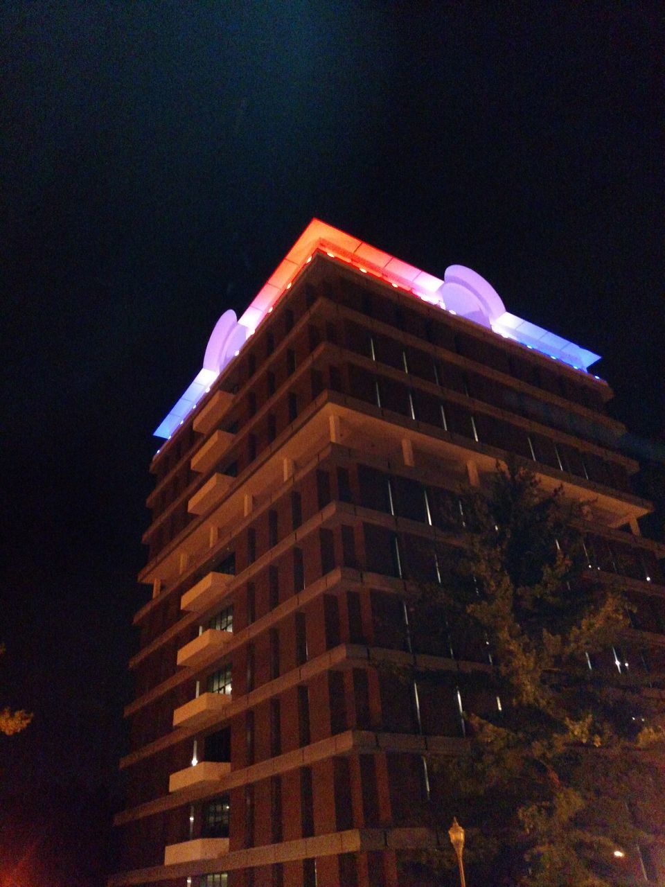 LOW ANGLE VIEW OF ILLUMINATED BUILDING