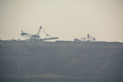 Machinery at coal mine against clear sky
