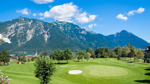 High angle view of golf course against sky