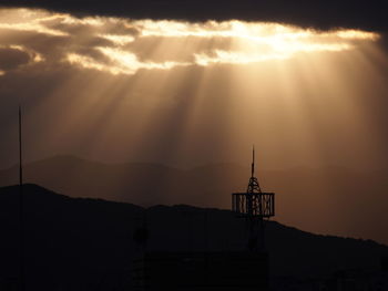 Silhouette mountain against sky during sunset