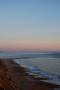 Scenic view of sea against clear sky during sunset