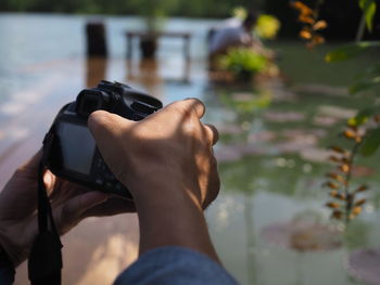 Close-up of man holding camera