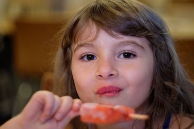 Close-up portrait of cute girl eating food