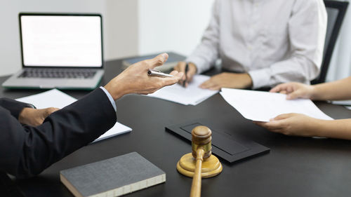 Midsection of business colleagues working at office