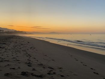 Scenic view of beach against sky during sunset