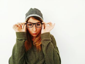 Portrait of beautiful young woman against white background