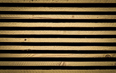 Full frame shot of wooden fence against black background