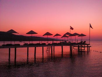 Pier on sea at sunset