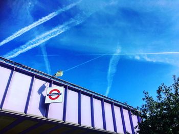 Low angle view of vapor trail against blue sky