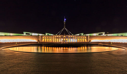 View of bridge over river at night