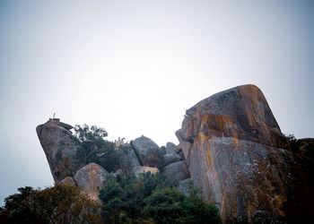 Low angle view of rock formations against sky