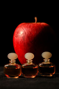 Close-up of red wine on table against black background