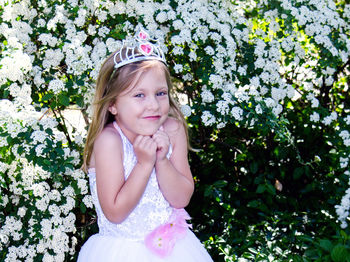 Little girl in a princess costume with toy tiara, is happy to be a young pretend royal