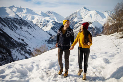 Young couple in love enjoying on winter vacation together on the mountain