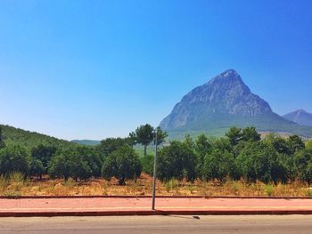 Scenic view of mountains against clear blue sky