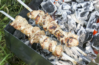 High angle view of meat on barbecue grill