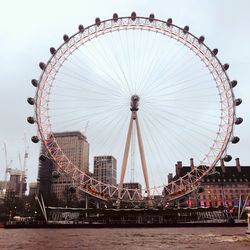 Low angle view of ferris wheel in city