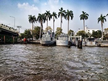 Boats in sea with buildings in background