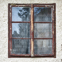 Close-up of glass window on wall of building