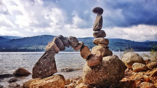 Rocks in sea against sky