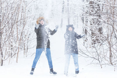 View of woman standing on snow covered land