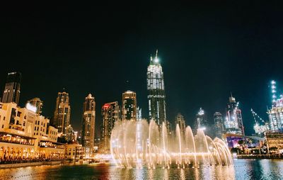 Illuminated buildings in city at night