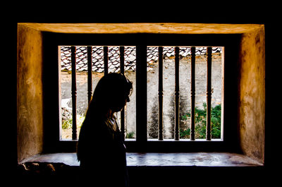 Man looking through window