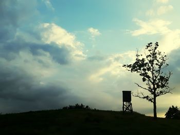 Low angle view of landscape against cloudy sky