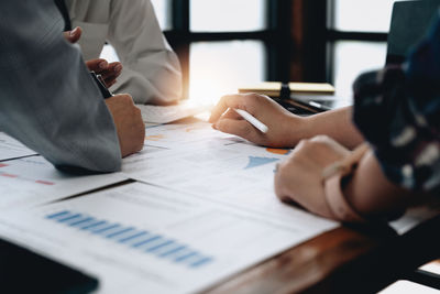 Midsection of business colleagues working at office