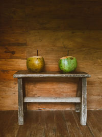 Fruits on table against wall