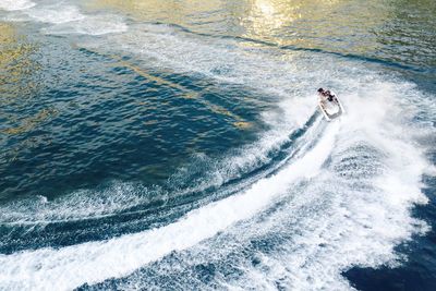 High angle view of man riding on sea